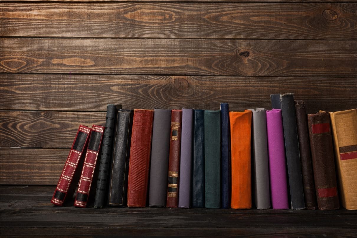 Books on wooden background with copy space. A rustic setting for reading and studying
